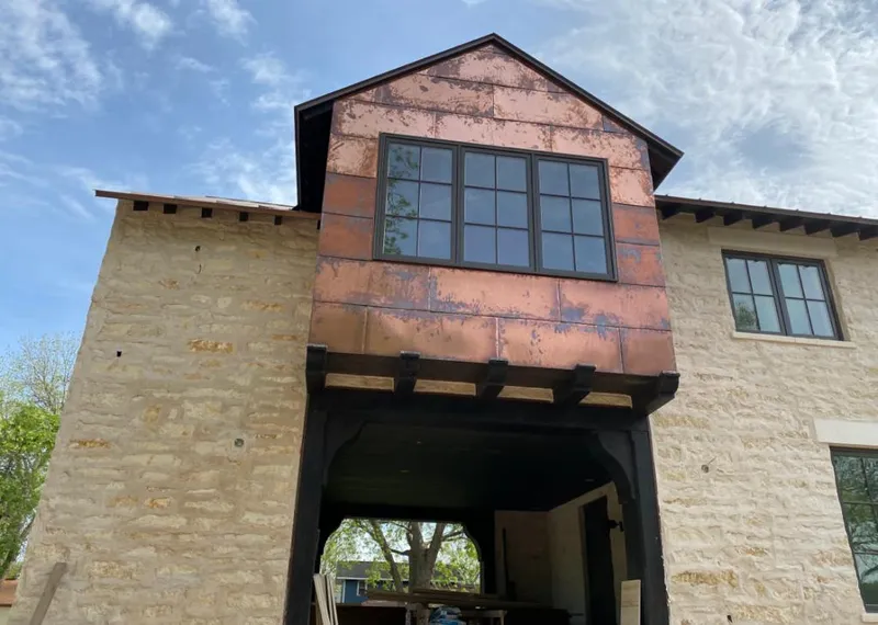 Copper metal panel facade on a stone building for Skylight Installation in Loomis