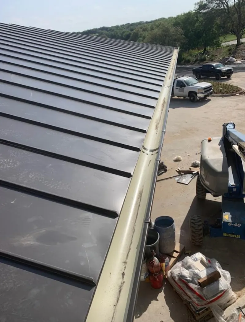 Standing seam panel and gutter detail on a metal roofing jobsite in Loomis